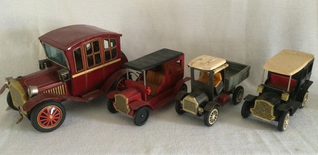Lot of Four Tin Model T Car Toys: One is a wind up (non functioning) as-is with headlamps; two are four passenger; one is a pick up truck. 9-1/2" to 6-1/2" long