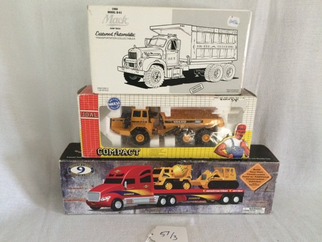 Lot of 3 Die Cast Construction Vehicles: Eastwood Automobilia, Transportation Collectibles, 1960 Model B-61 Mac Dump Truck; Joal Compact Volvo A35C; Sunoco 2002 Edition Construction Carrier. 11" long; 12-3/4" long; 16-3/4" long - the box siz