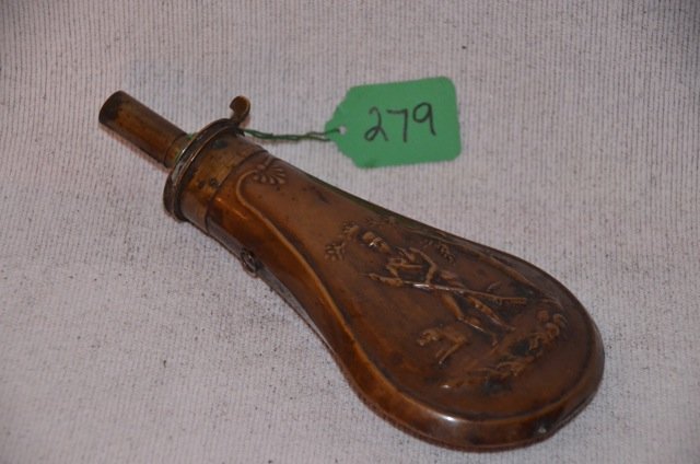 Copper and Brass Powder Flask: Turn of the Century copper and brass powder flask with embossed hunter and his dog. 7" high