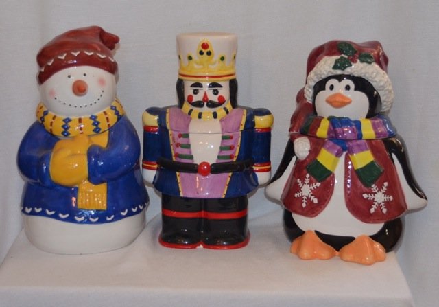 Three Winter Themed Cookie Jars: Snowman, Nutcracker and Penguin. Made in China. Approx 7-1/2" w x 11" high