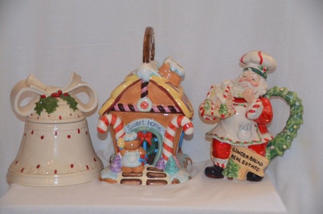 Three Christmas Cookie Jars: A bell, a gingerbread "Sweet Home" house; and Santa gingerbread maker. 8" x 8"; 7-1/2" x 12"; and 7-1/2" x 10"