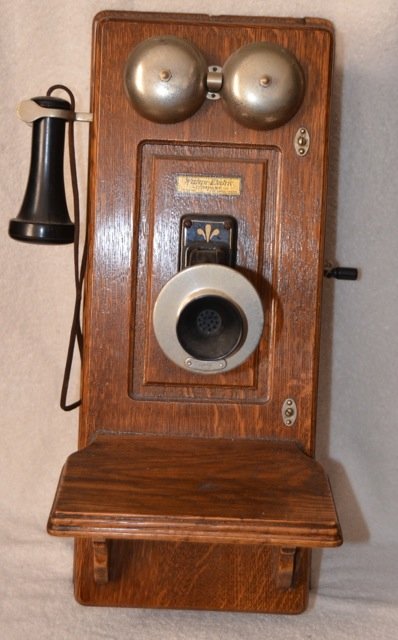 Antique Oak Cased Wall Telephone: Western Electric Company label at front. The Vought - Berger Company, Makers of Telephones and Switchboards, La Crosse, Wis. USA. Hand crank. Front shelf. 9-1/2" wide x 12" deep (including shelf) x 23