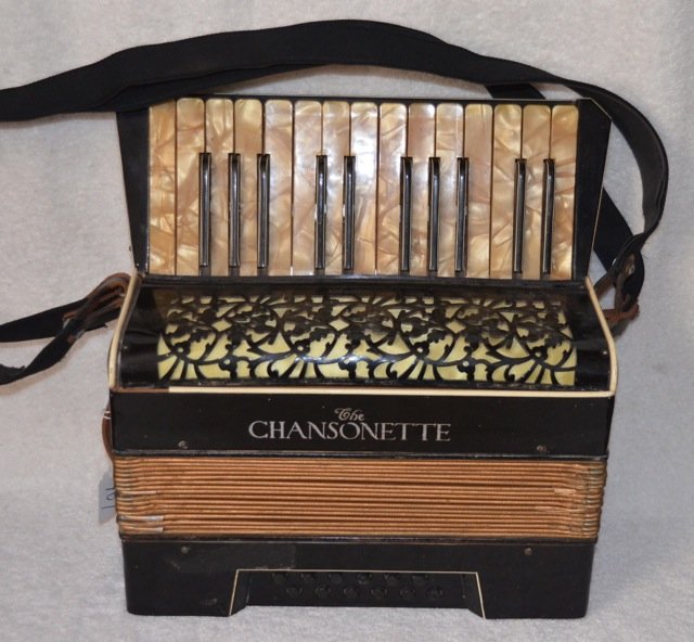 The Chansonette, German Piano Accordian: Black lacquer and plastic. Leather straps. Made in Germany. Nice design. 6-1/2" x 12-3/4" x 13" high