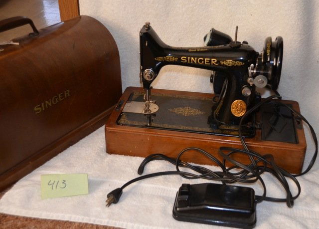 Singer Sewing Machine: Wood case with handle. Lock and key. Portable black sewing machine. Electric. Serial # EF936252. Singer Manufacturing Great Britian. Made in USA. 17-1/2" x 7-1/2" x 12-1/2" high case size