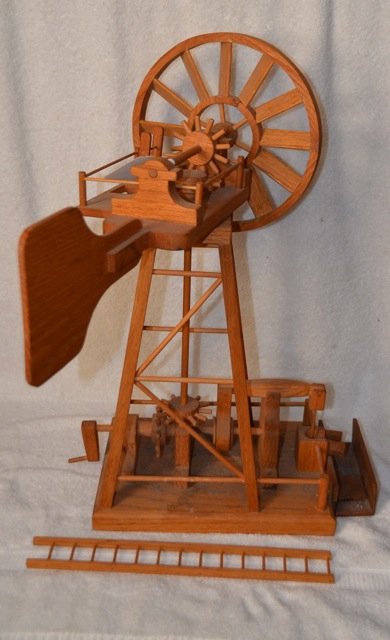 Model Windmill Well Machine: Wooden. Ladder as is. Hand crank to control the windmill. Indiscernable logo at the front. 23" high