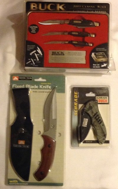 Five New in Packing Knife Sets: 3 - Ozark Trail fixed blade knives; 1 - Schrade Tough Camo folding knife; 1 - Buck 2007 Classic Bolt Collector's Series knife set.