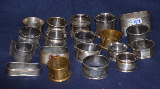 Lot of Silverplated Napkin Rings (19): Assorted Victorian silver plate napkin rings. All unmatching to each other. Some with small cracks as shown in photos. 1-3/4" to 1/2" high in varying sizes.
