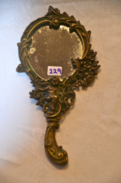 Brass Hand Mirror with Cherub: Scroll, floral and cherub decorated. 8-3/4" long