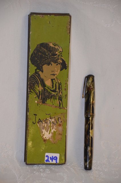 Beautebox Jackie Coogan and Waterman Pen: Canco Beautebox Tin Pencil Box of Jackie Coogan "The Kid" together with a Waterman fountain pen. Green and black marbled design. Both pieces in as found condition. 7-3/4" long x 2" wide; 5" long