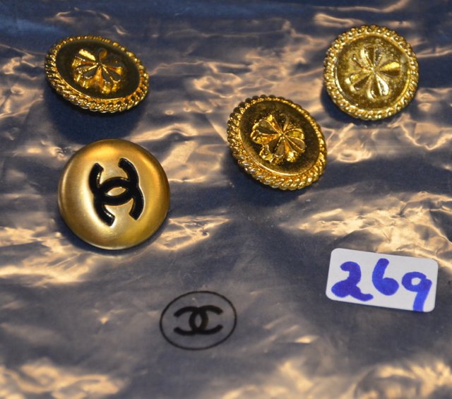 Four Circa 1980's Channel Buttons: Unused "extra" Channel buttons. Three have the gold four clover leaf design, two larger than the one smaller. The fourth is the Channel double "C" logo in lack on a gold button. 3/4" dia.; 1/2" dia.;