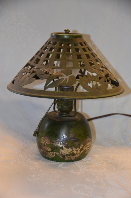 Heintz Silver Overlay Boudoir Lamp: Arts and Crafts silver overlay boudoir lamp. Buffalo, NY. Verdigris patina with silver overlay. Inside of shade is missing its original Mica lining. Needs a cleaning, small dent as shown in photo. In 