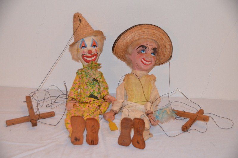 Two Vintage Marionette Puppets - Clown & Man: Two vintage marionettes with plaster faces and molded plastic hands. Linen costumes. 17" high; 16" high