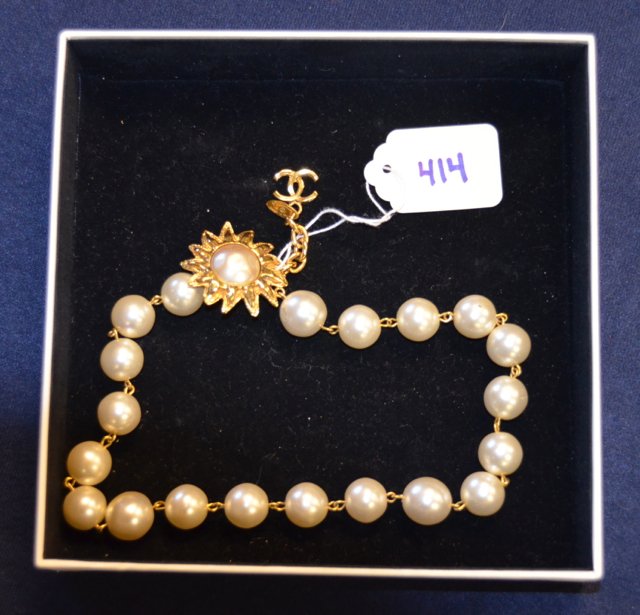 Chanel Faux Pearl Choker with Sunburst: Vintage Chanel faux pearl choker with sunburst hook clasp and Chanel crossed "C" logo at the chain termination. Twenty large pearls (one with some minor damage as seen in photo.) Signed Chanel, Made i