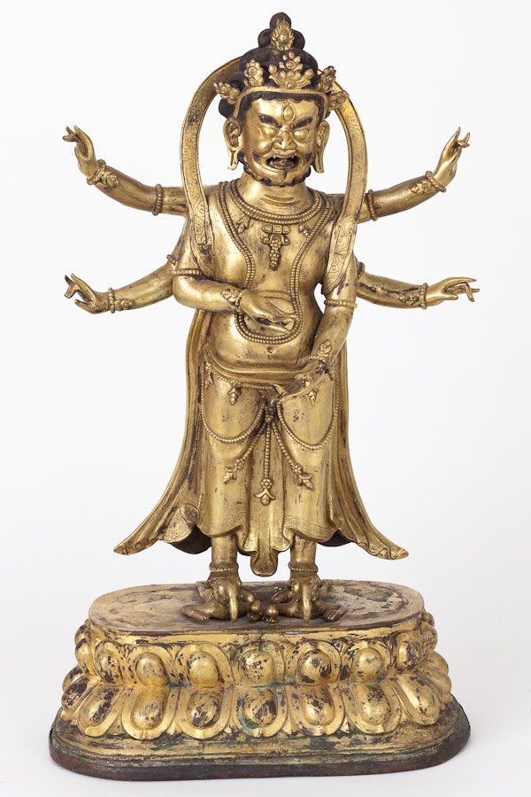 Sino-Tibetan Gilt Bronze Figure of Buddhist Diety: Sino-Tibetan Gilt Bronze Figure of Buddhist Diety.A Gilt Bronze Statue, with the principle Buddhist figure standing on backs of two recumbent elephant headed figures, on a lotus form base capped in pa