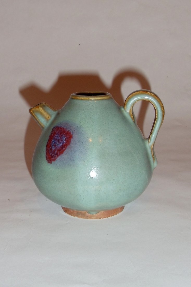 A Junyao-Styled Wine-Pot with a Rosy Splash: This wine-pot, elegantly shaped, is glazed in sky-blue. It bears an artistic rosy pattern which is an accidental result during its firing. Its foot-rim is unglazed. Height: ４¼ inches (10.8 cm)