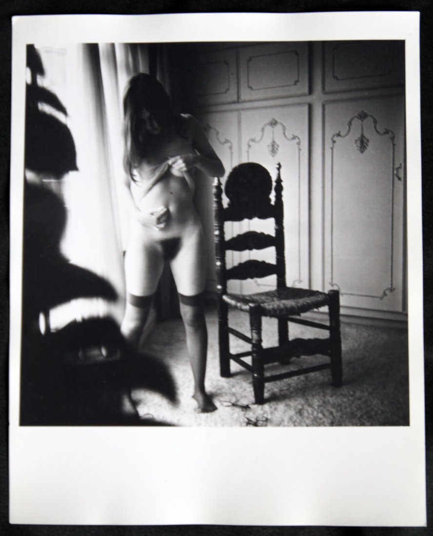 Two Gillian Duxbury Original Nude Silver Gelatin Prints: The first original erotic silver gelatin photo by Bob Guccione of Gillian Duxbury, Penthouse Pet as Billie Dean in 1972, looking at her sensual body in a small hand mirror inside a dimly lit doorway.