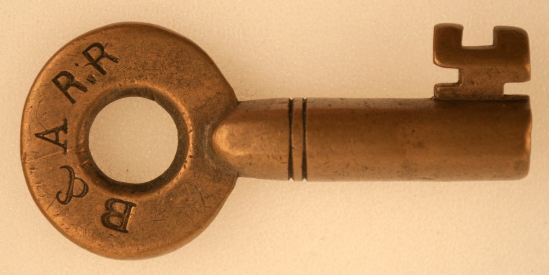 B&A Railroad Key: Brass switch key with serif letters B&ARR with tapered barrel and double rings. We are unclear if this is Boston & Albany or Bangor & Aroostook, or possibly something else entirely. We have a couple o