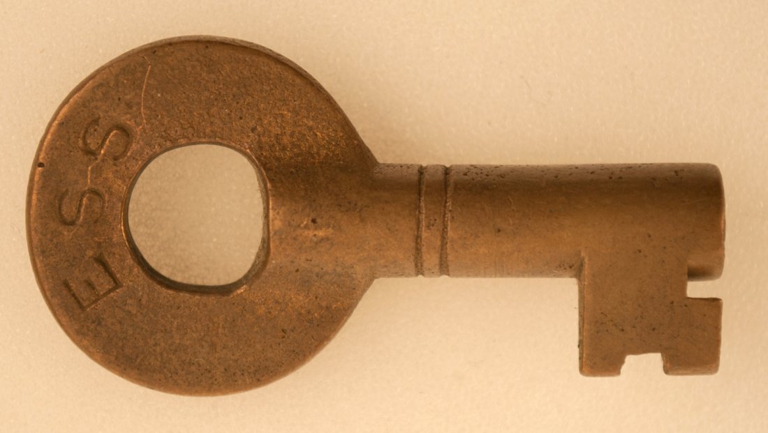 ESS Railroad Key: Brass switch key with block letters ESS and double rings on barrel. We do not know what this key is from. Marked on back with FRAIM stamp.