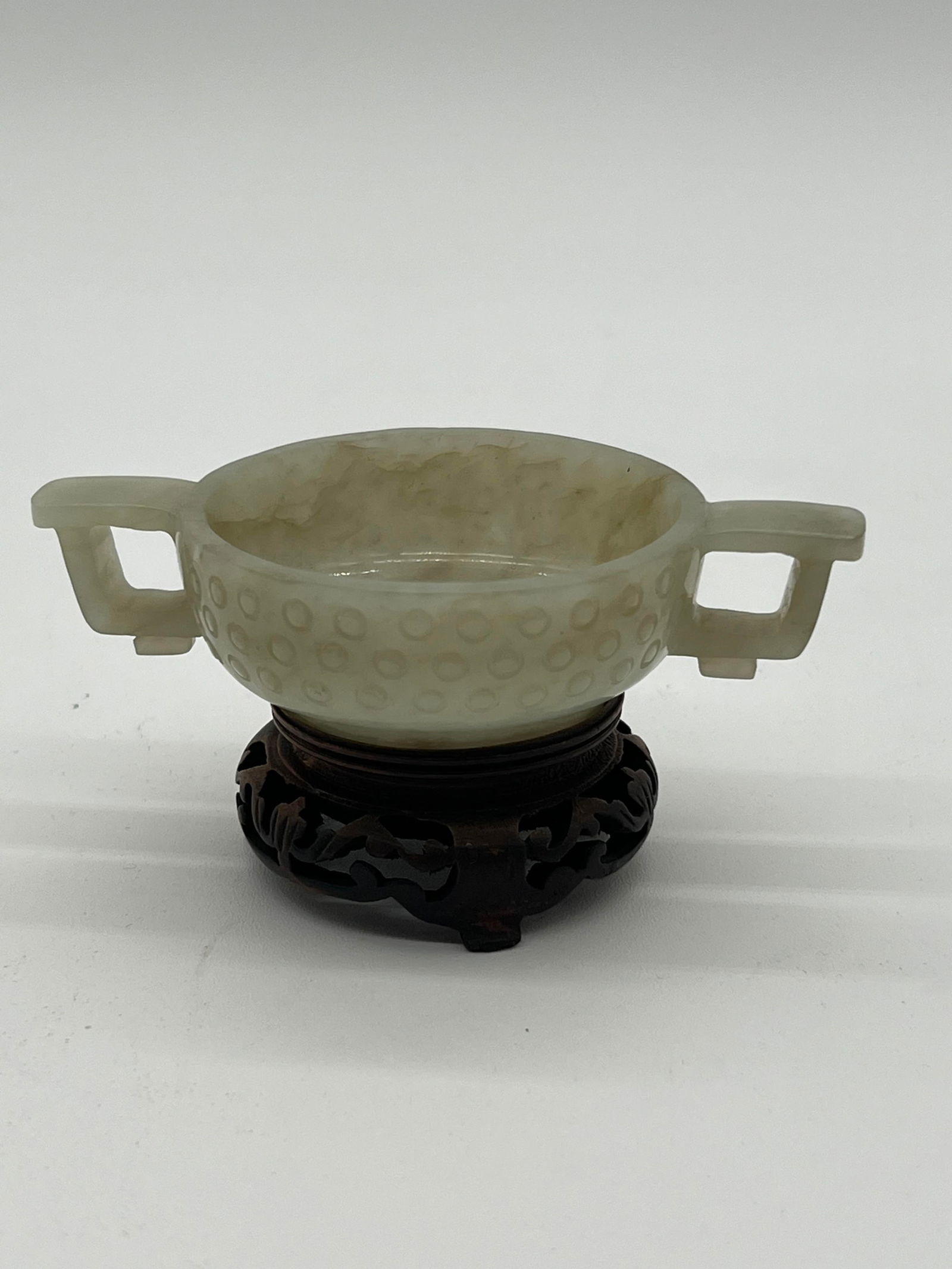 A Chinese nephrite jade vessel with handle on wood base (1 of 17)