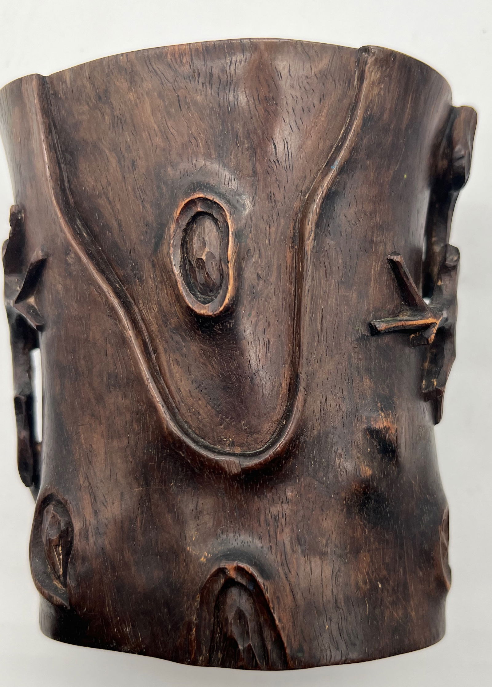 A Chinese Zitan wood carved brush pot: 19th century, The carved details simulate knots and irregularities found in tree bark, creating a realistic effect. Height: 4.5 inches; Length: 4 1/4 inches