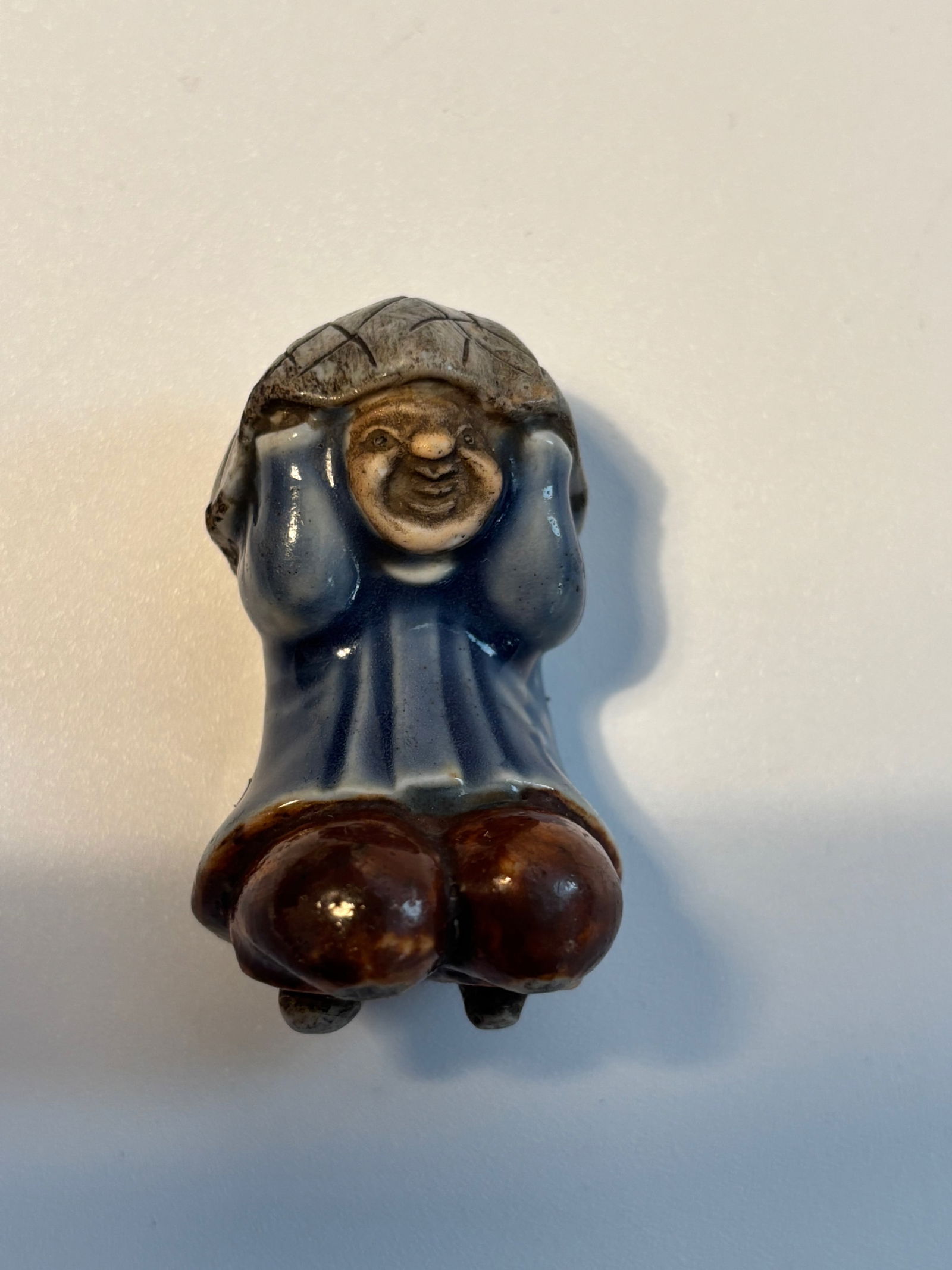 A Japanese Hirado porcelain netsuke of a Hirado boy, Edo period (1603-1868) (1 of 9)