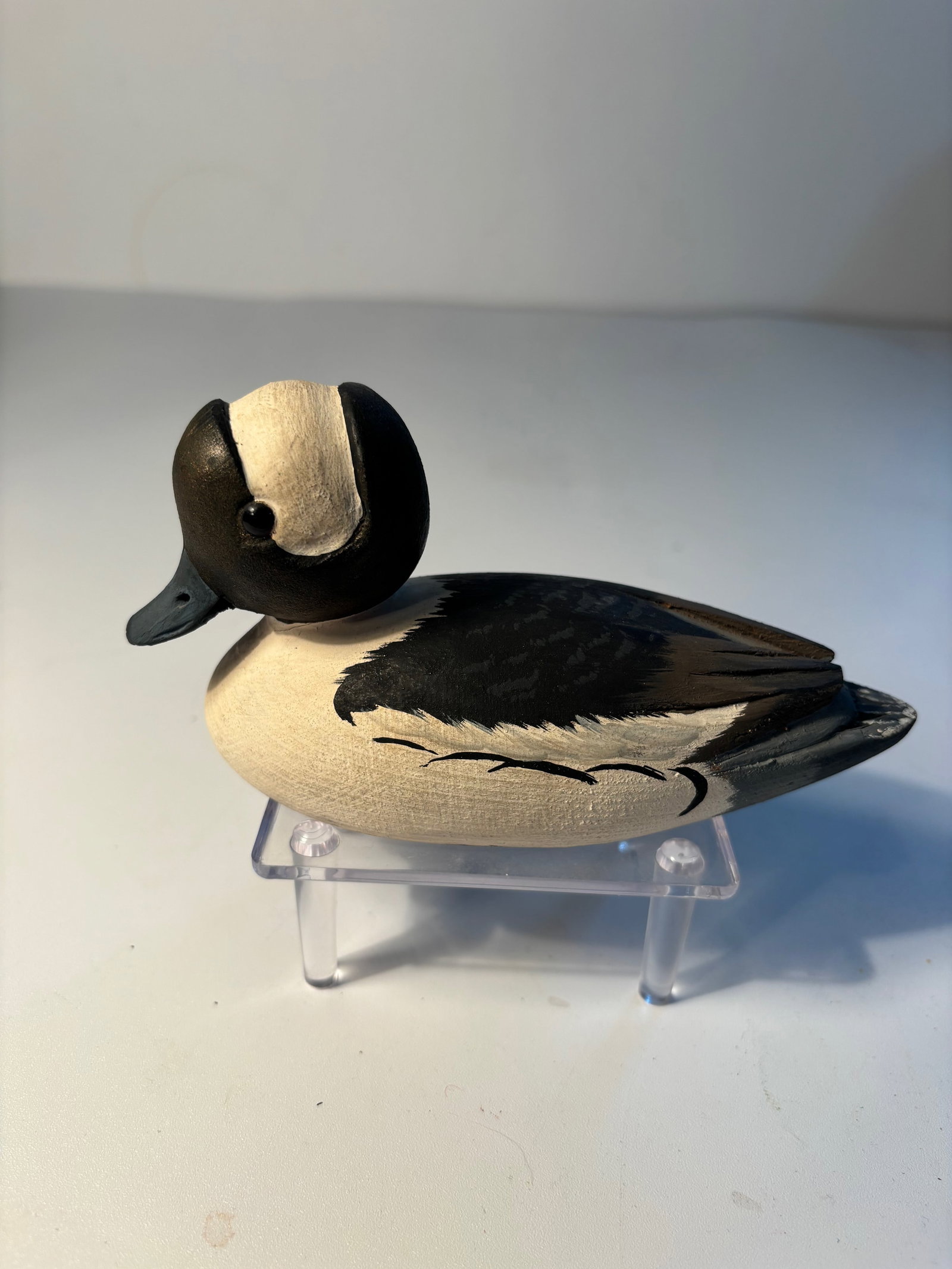 Tom Hunter carved wooden"Buffle-Head" male decoy signed: A vintage hand-carved wooden "Buffle-head" male, created by Tom Hunter of Flesherton, Ontario, Canada. The artist’s signature and the bird’s description are prominently marked on the bottom. Tom H