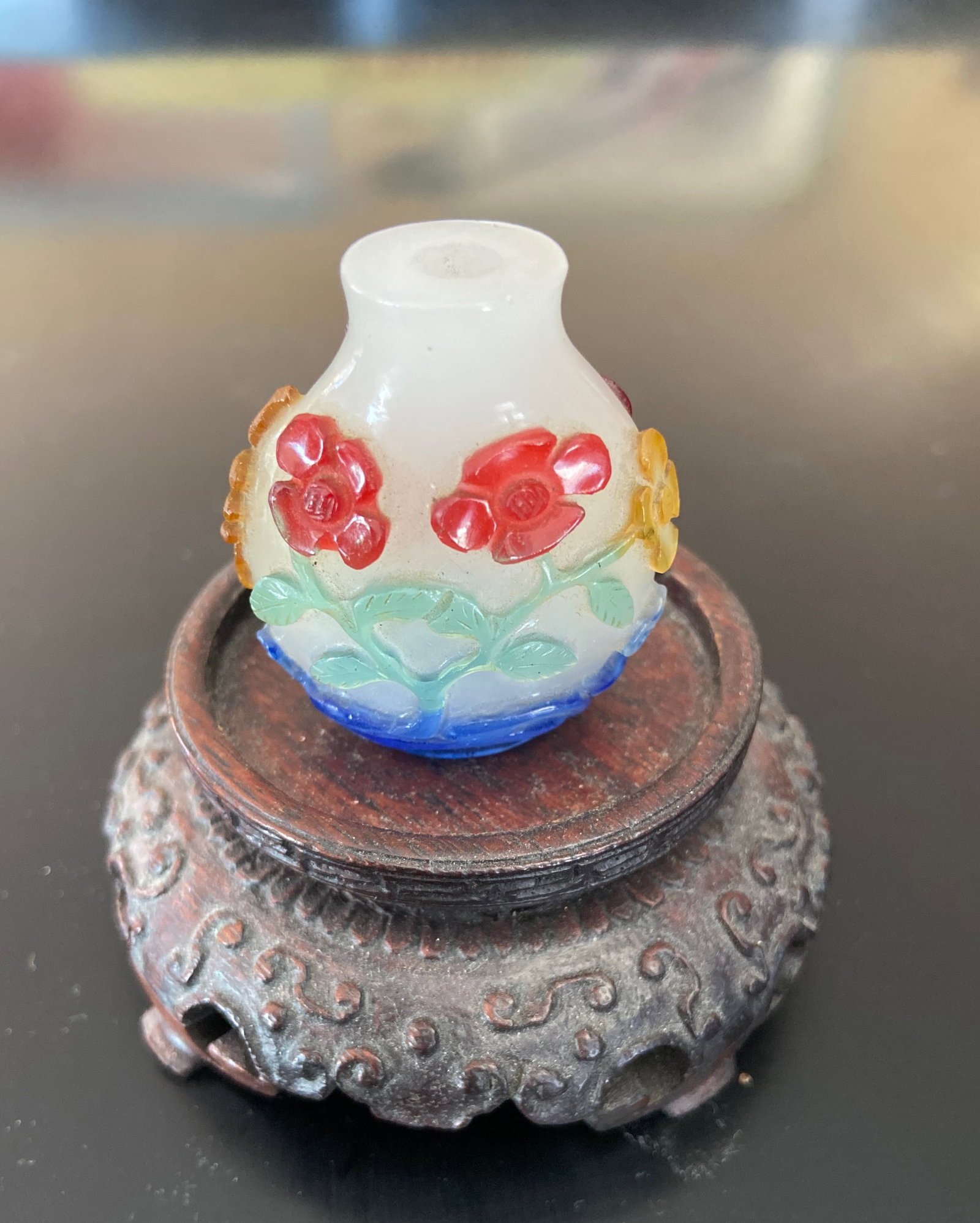 A Chinese 5-color overlay hand carved glass snuff bottle: Qing Dynasty (1644-1912); This is a rare 5-colour overlay snuff bottle. The intricate floral decorations and multicolored glass . Height: 4cm.Provenance: From an prominent Midwest family collection in