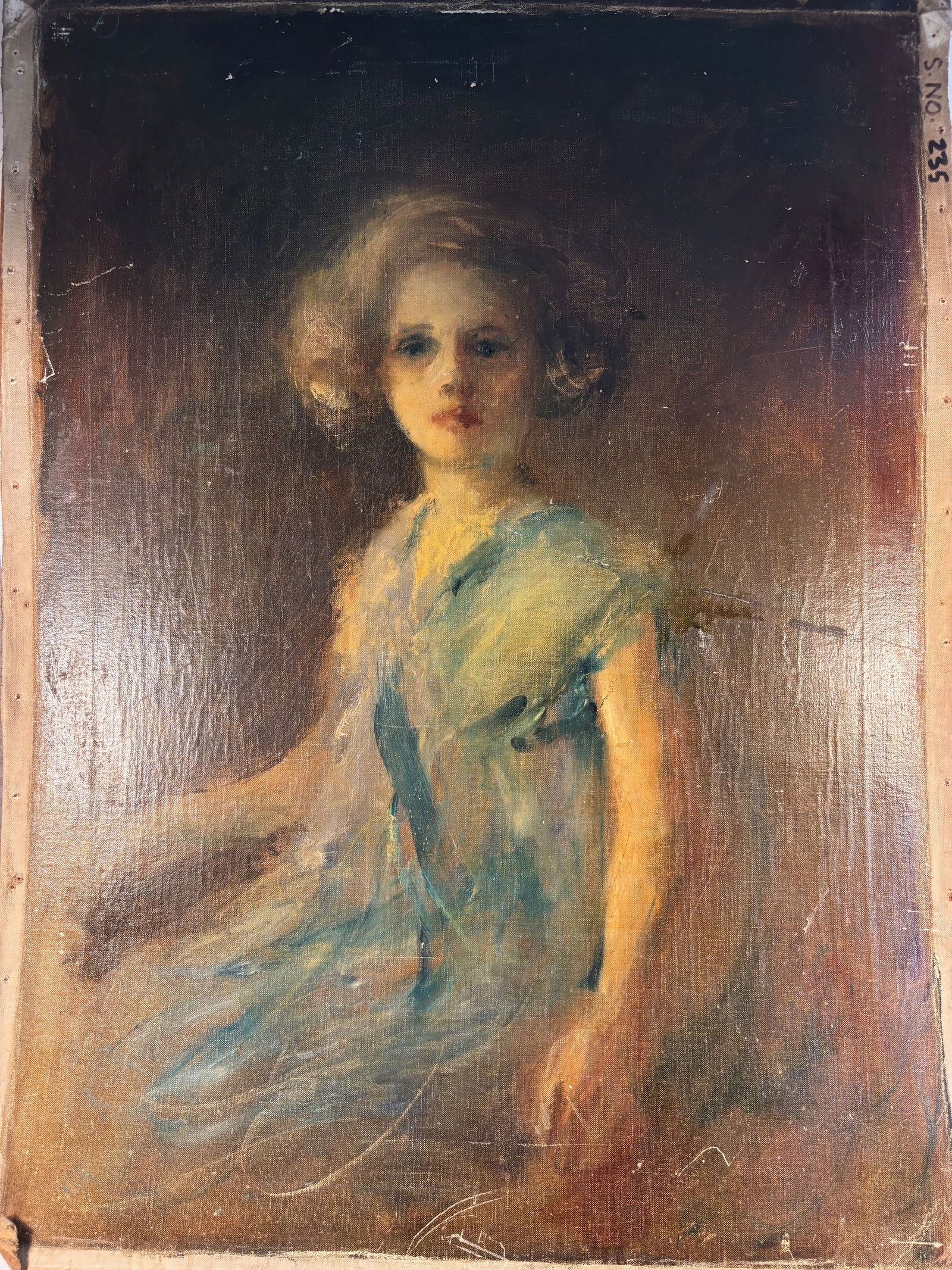 A Portrait of a Young Girl in Blue, Continental School, Oil on Canvas: A delicate and emotive oil painting of a young girl with curled blonde hair in a soft blue dress, seated against a richly toned background. The artist captures the child’s innocence and expression w