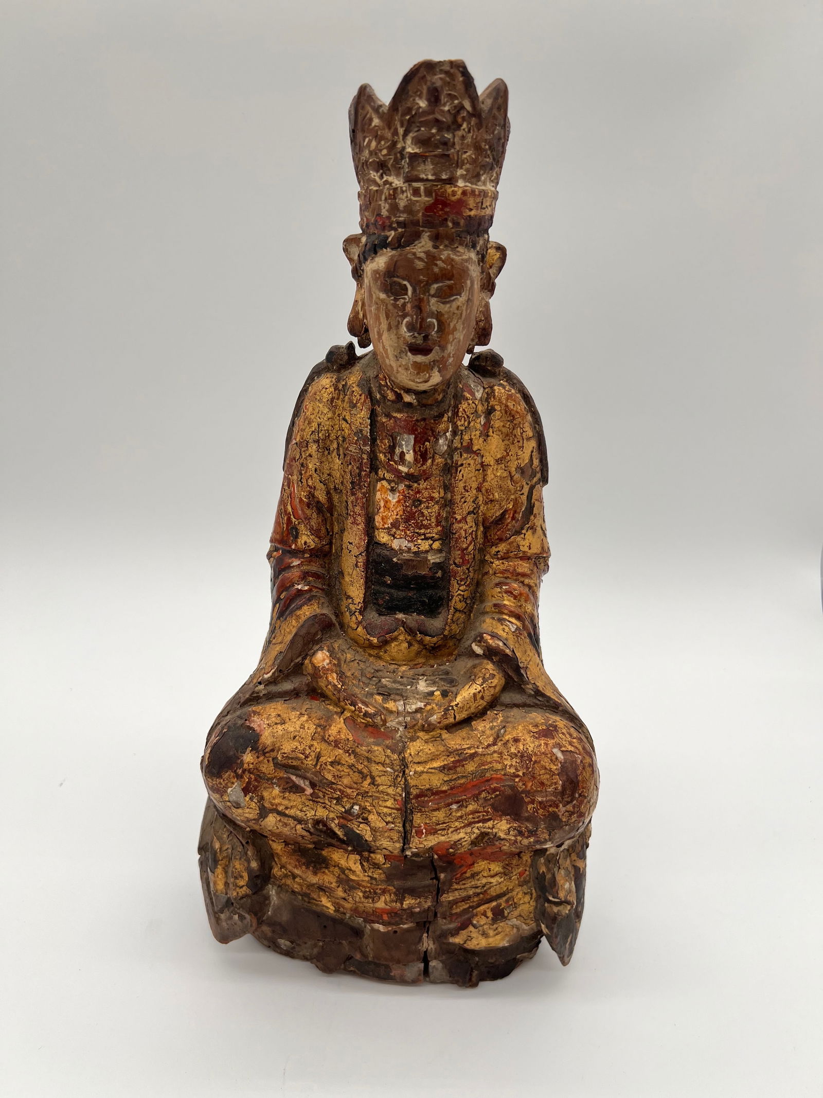 A Chinese gilt Wood Buddha statue: The gilt wood seated Buddha from Qing Dynasty (1644-1912). The statue has a rectangular cavity on its back, which could have been used for ritualistic purposes or for placing relics, a common feature
