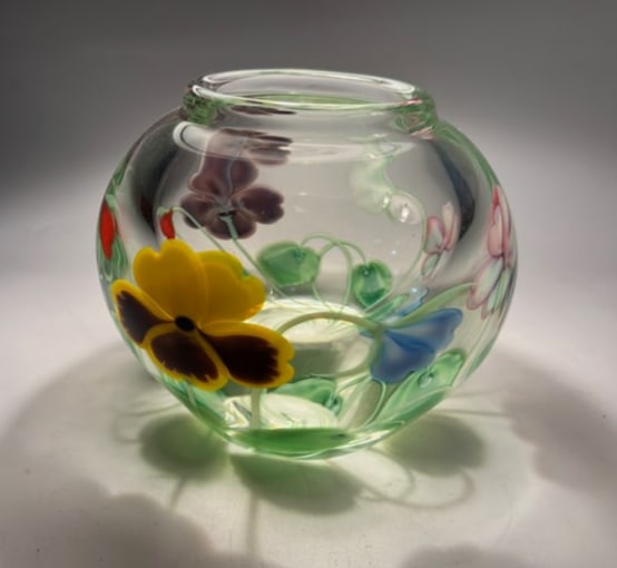 Studio Art Glass Floral vase: This stunning round and heavy art glass vase features vibrant, hand-encased pansy-style flowers in vivid colors, including yellow, purple, red, and green. Expertly crafted with intricate internal flor