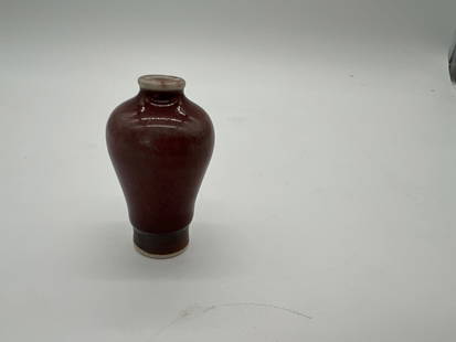 A Chinese Sang De Boeuf Meiping Shape Vase: Qing dynasty (1644-1912) ; The glossy, reflective surface shows the even and rich application of the Sang De Boeuf glaze. The unglazed white foot and the dark brown glaze near the base. Height: 6.5 cm
