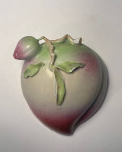 A Chinese Famille rose porcelain wall vase: 18th century; Porcelain wall vase shaped like a fruit, likely a peach, with a vibrant glaze that transitions from green to red. Height: 4 5/8 inches