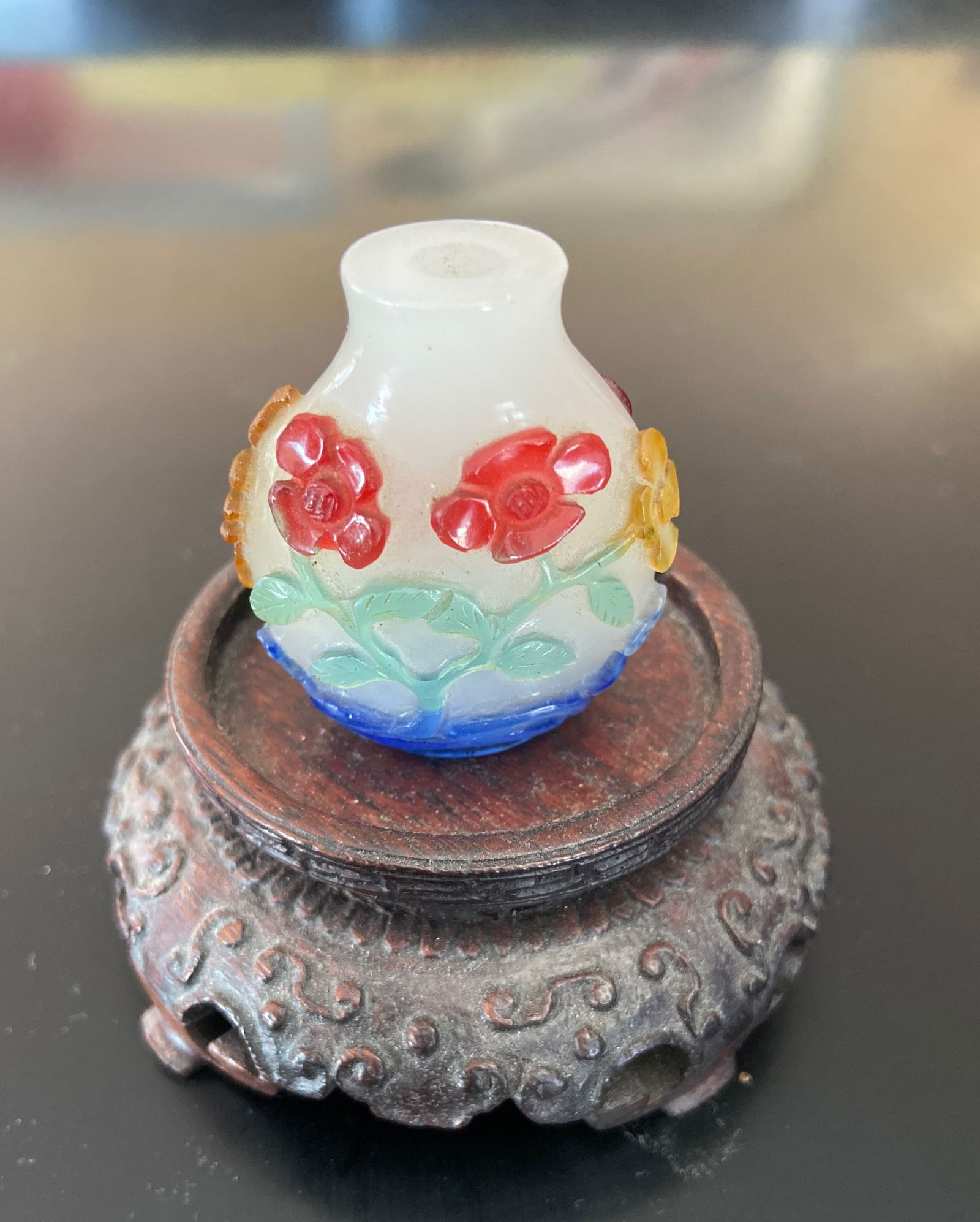 A Chinese 5-color overlay hand carved glass snuff bottle: Qing Dynasty (1644-1912); This is a rare 5-colour overlay snuff bottle. The intricate floral decorations and multicolored glass . Height: 4cm.Provenance: From an prominent Midwest family collection in