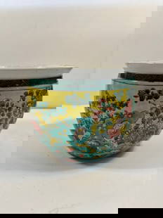A Chinese Famille Verte porcelain jardinière: Qing Dynasty (1644-1912);Rich enamels in green, yellow, red, and turquoise depicting flowers and rocks ; Height: 6 INCHES ; Diameter: 6.25 INCHES.