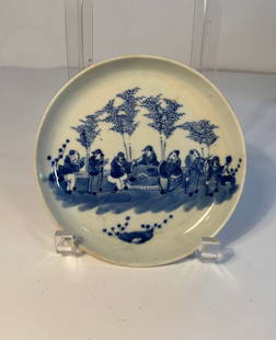 A Chinese blue and white porcelain plate with mark "NeiFu": Qing dynasty (1644–1912); The scene depicted on the plate appears to align with the Seven Immortals, figures from Chinese mythology and Daoist tradition, often portrayed in group settings enjoying l