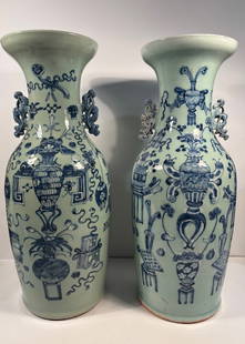 Two large Chinese blue and white and celadon green glaze porcelain vases: Qing Dynasty (1644-1912). It features classic Chinese motifs—such as scrollwork, stylized floral arrangements, and possibly scholar’s items (like scrolls or vessels).The handles are shaped like st