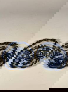 Pair of Chinese Export Blue and White Porcelain Dishes: Qing Dynasty(1644-1912); A pair of small hand-painted porcelain dishes with lobed rims, decorated in underglaze blue with traditional Chinese river landscape scenes including pagodas and pine trees. A