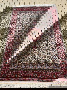 A Fine Persian  Kashan Rug 100% silk: Probably Circa 20th Century; A luxurious hand-knotted Persian silk Kashan rug featuring an ivory central field with an ornate floral medallion and deep red border. Woven entirely from silk on a silk o