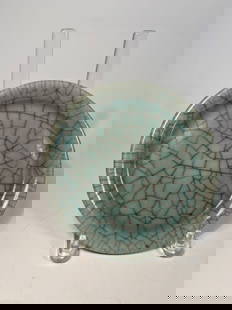 A Chinese Celadon Dish with Crackled Glaze Plate: Ming dynasty(1368-1644) to Qing dynasty (1644-1912); A Chinese celadon-glazed dish,of shallow circular form with a broad, slightly everted rim. The body is covered overall in a thick, pale grayish-gre