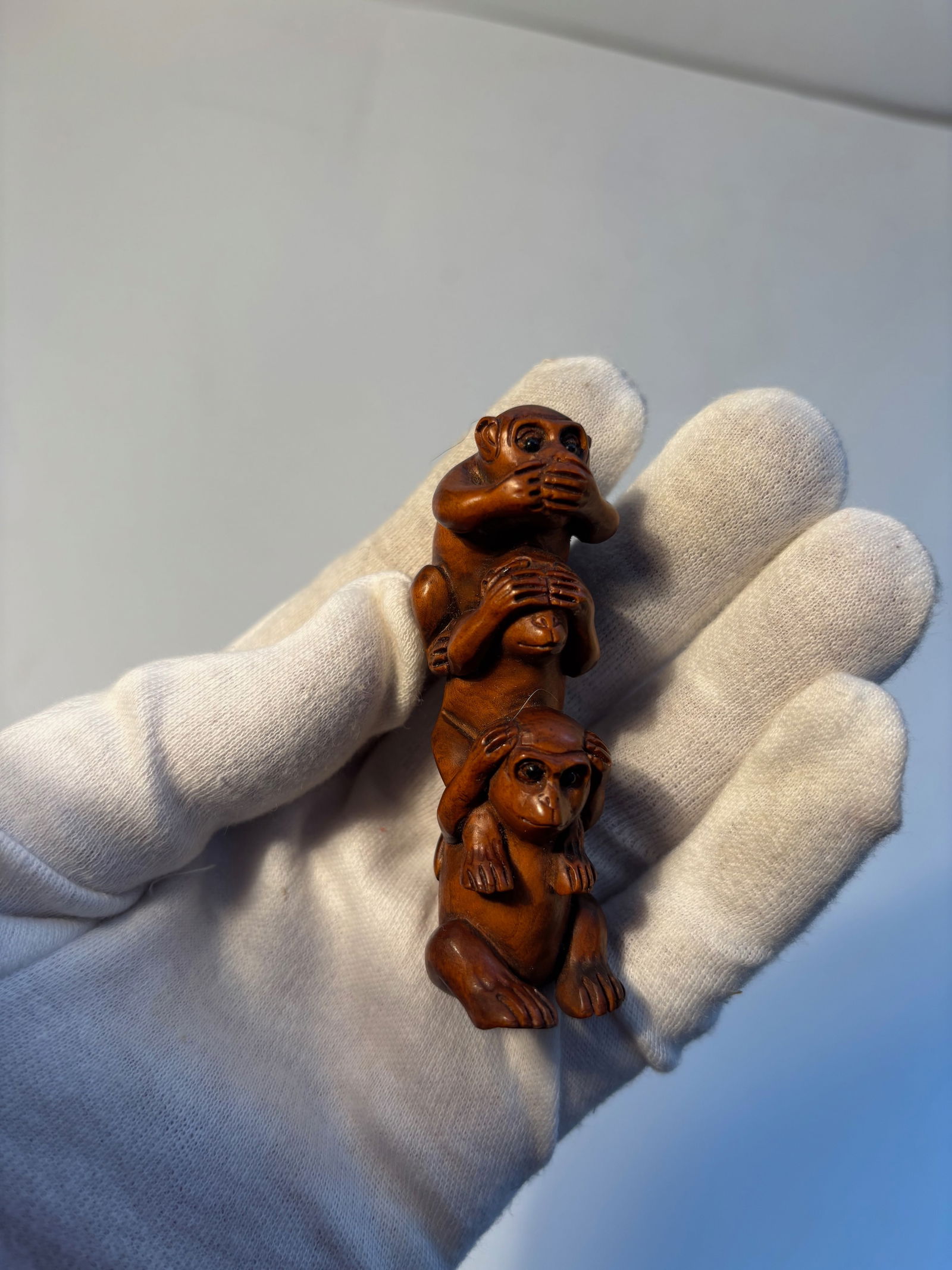 A Japanese boxwood carved three monkeys netsuke (1 of 9)