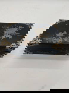 A Japanese lacquerware box with metal corner protectors: 19th century; This is a beautiful Japanese lacquerware box with intricate decoration and metal corner protectors . The box features a black lacquer base with an elegant floral and bird motif. Measures