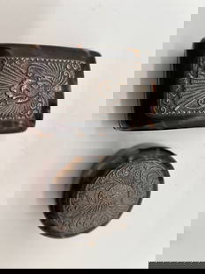 A set of 2 turtle shell jewelry boxes with silver phoenix carving top: It seems that the two items have decorative tops featuring intricate engravings of birds, and they are made from or designed to look like turtle shells. One round box diameter: 2 inches ; the other re