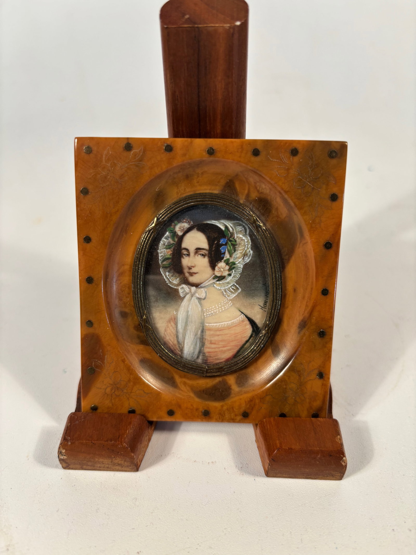 Miniature Portrait Painting signed by artist: A finely executed 19th-century miniature portrait of a young woman, painted with remarkable detail and delicacy. The subject is portrayed in period attire with a white scarf, pearl necklace, and flora