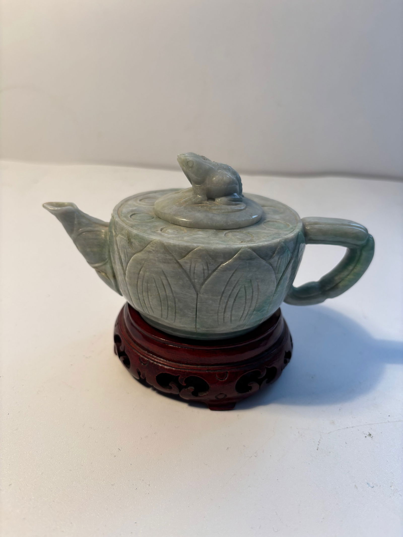 A Chinese hand carved Jadeite teapot: Qing Dynasty (1644-1912); Height: inches
