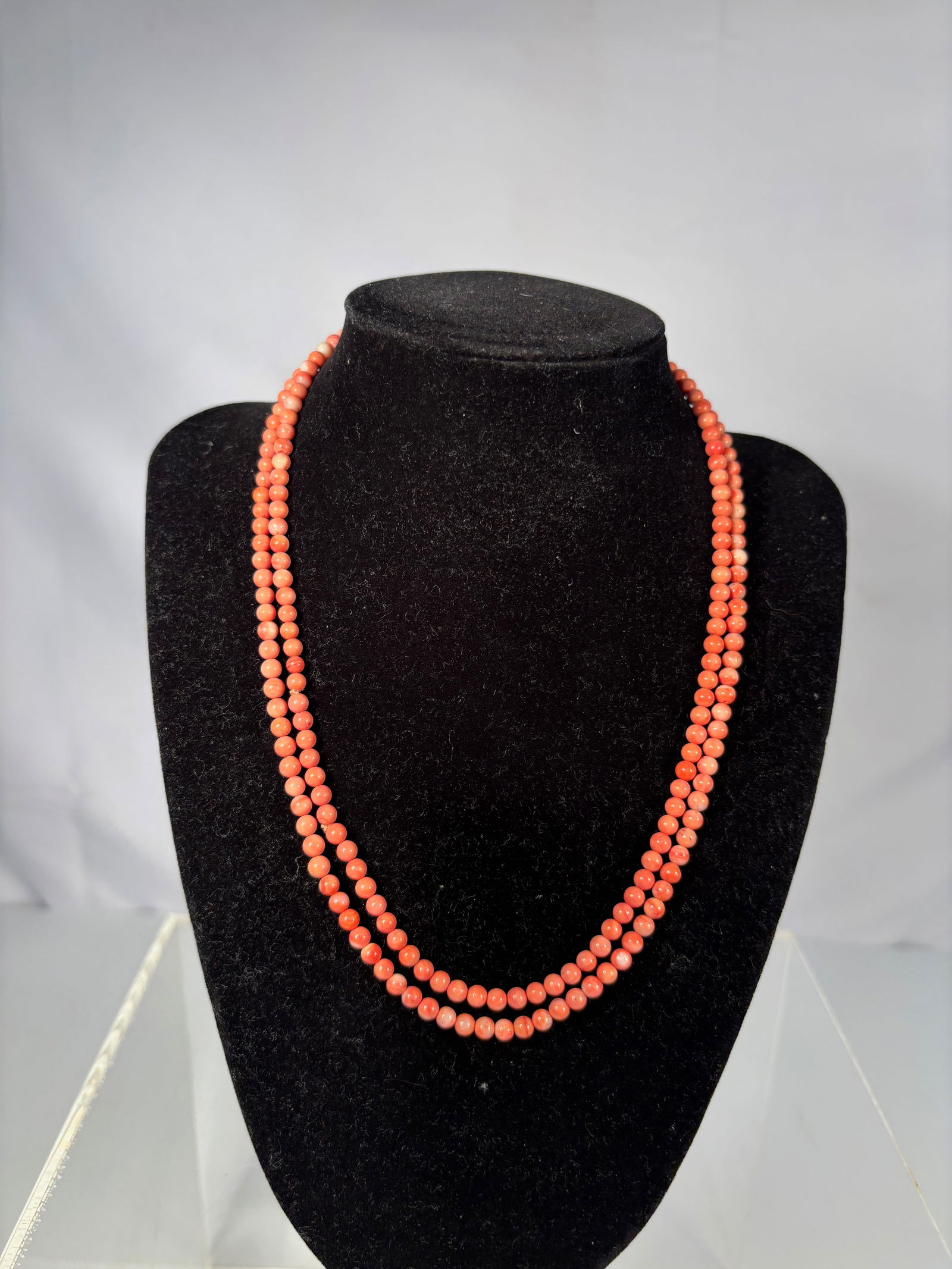 Vintage Mediterranean Coral Bead Necklace, 35 Inches: A vintage single-strand necklace of genuine coral beads, measuring approximately 35 inches long. The round coral beads display rich natural shades of red-orange with subtle variation, characteristic o