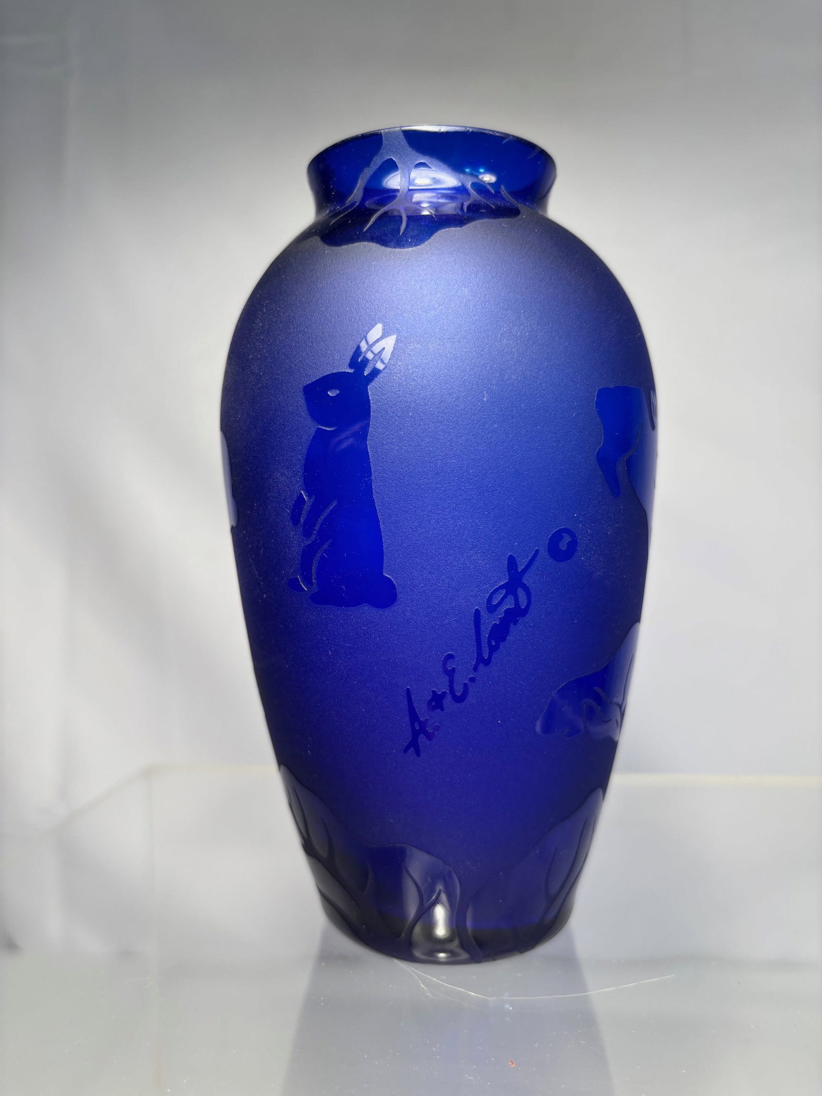 A&E Arthur Court Blue Cameo Glass Vase – Acid-Cut Rabbits: art glass vase of cobalt blue cased glass, decorated in cameo-style with frosted cut rabbits in silhouette. Dimensions?Height: 6 inches.