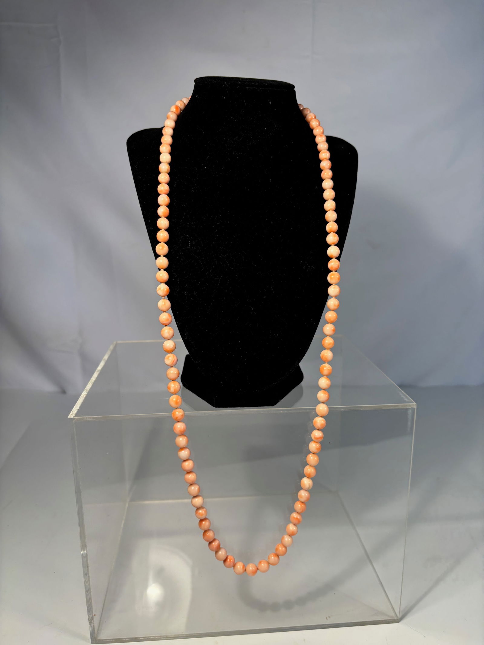 A Coral Bead Necklace, Salmon Tones 32 inches: Strung as a long continuous strand, with natural inclusions and minor surface wear typical of antique coral. Popular throughout the 19th century .Dimensions?Length: 32 inches.