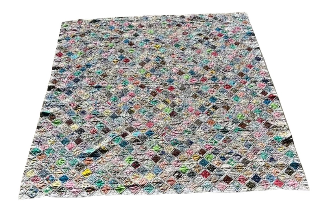 Hand-stitched “Cathedral Window" Quilt with Vintage Fabric Insets 77 x 81 in.: A meticulously hand-stitched Cathedral Window quilt featuring hundreds of colorful cotton print insets framed by white muslin folds. Each square displays a unique vintage fabric, creating a stained-gl