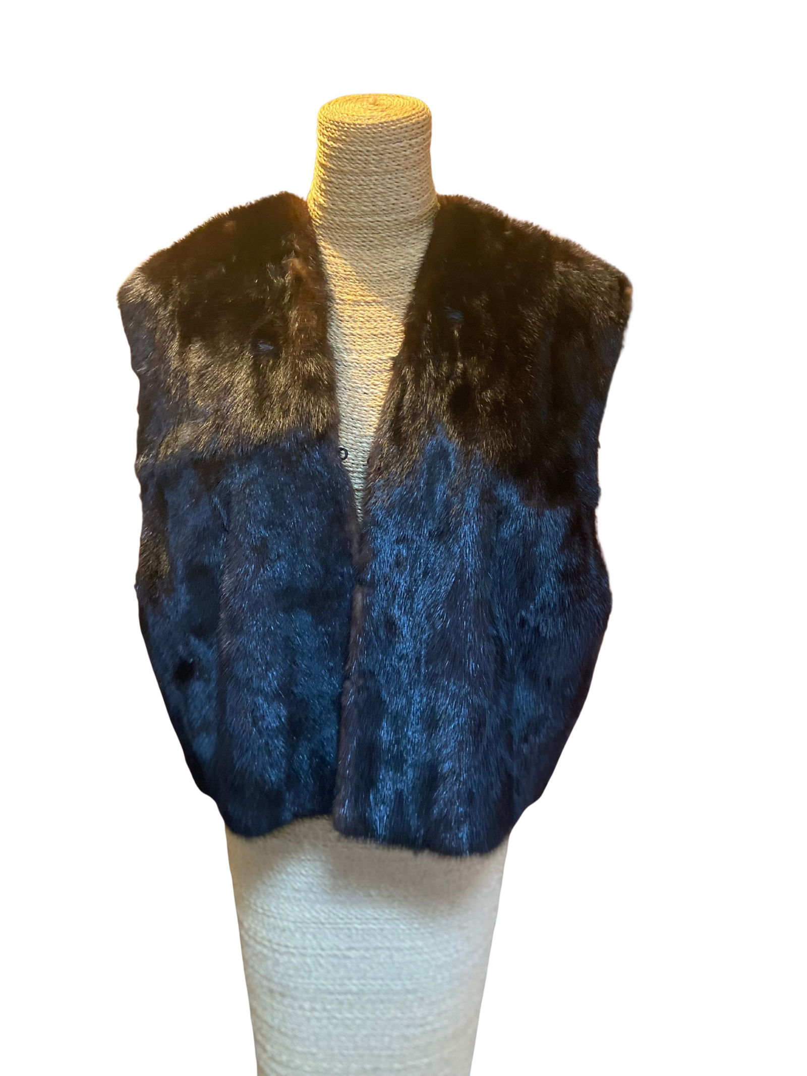 Dark Brown Mink Fur Vest: Dark brown mink fur vest, featuring a rich, glossy pelt with a smooth and even texture. The vest is designed in a classic sleeveless silhouette with a softly structured drape and open front, allowing