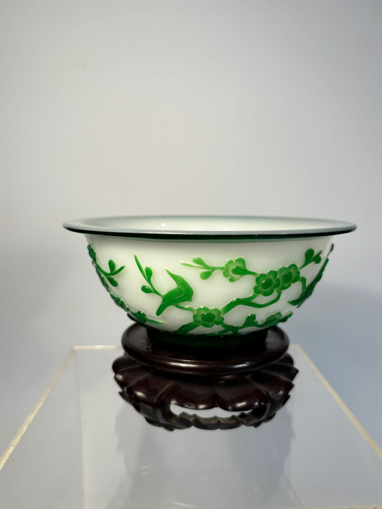 A Chinese Green Overlay Peking Glass Bowl: Qing Dynasty(1644-1912); A beautifully executed Chinese overlay Peking glass bowl, carved in vibrant emerald green glass over an opaque white ground. The overlay has been skillfully cut away to reveal